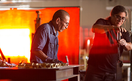 Two blacksmiths working in studio