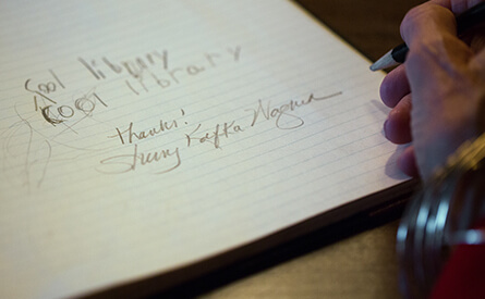 Woman signing her name in guestbook